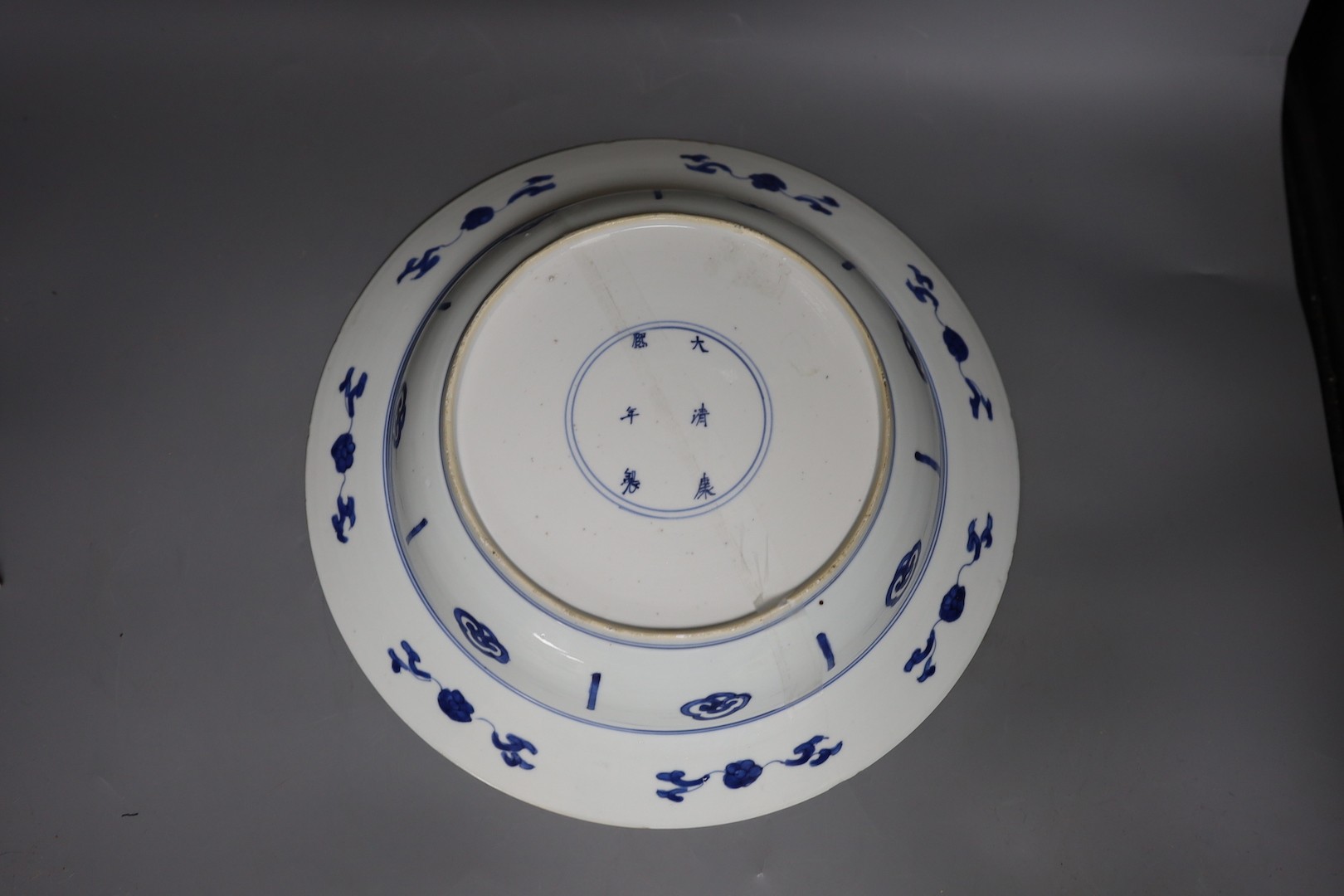 A Chinese blue and white ‘ladies’ basin, Kangxi period, cracked 34cm